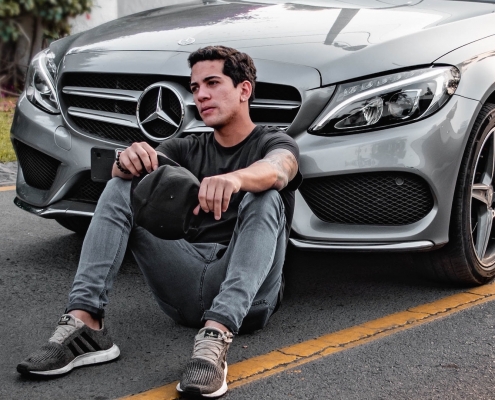 Influencers in front of a mercedes car