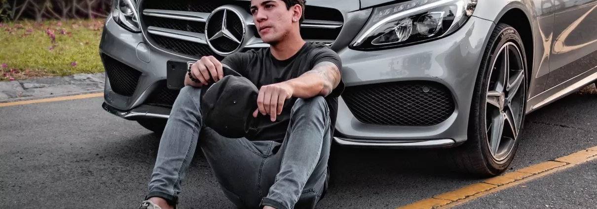 Influencers in front of a mercedes car